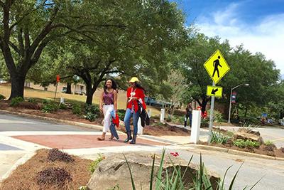 Students walking across crosswalk.